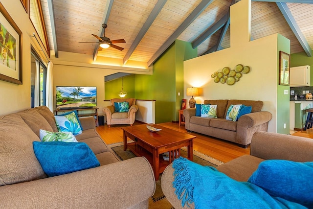 living room featuring beam ceiling, light wood-type flooring, high vaulted ceiling, and ceiling fan