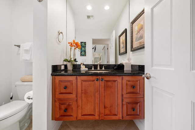 bathroom featuring toilet, vanity, and tile patterned floors