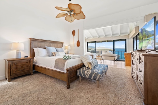 bedroom featuring light carpet, lofted ceiling with beams, access to outside, and ceiling fan