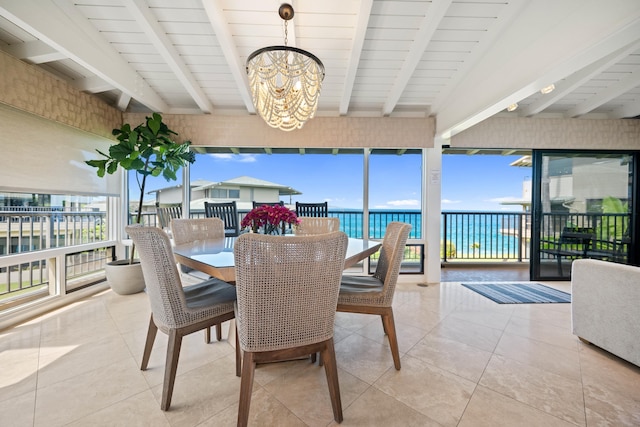 sunroom featuring beamed ceiling, a water view, a notable chandelier, and wood ceiling