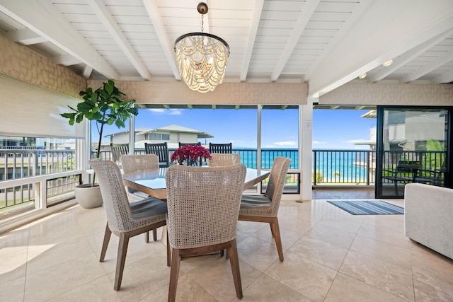 500 Bay Dr Unit 28B2, Lahaina, HI 96761 - tiled dining area featuring a chandelier, beam ceiling, healthy amount of natural light, and a water view