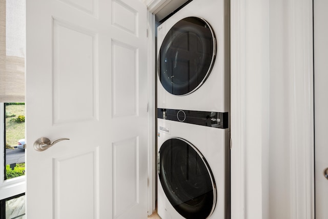 washroom featuring stacked washer / drying machine