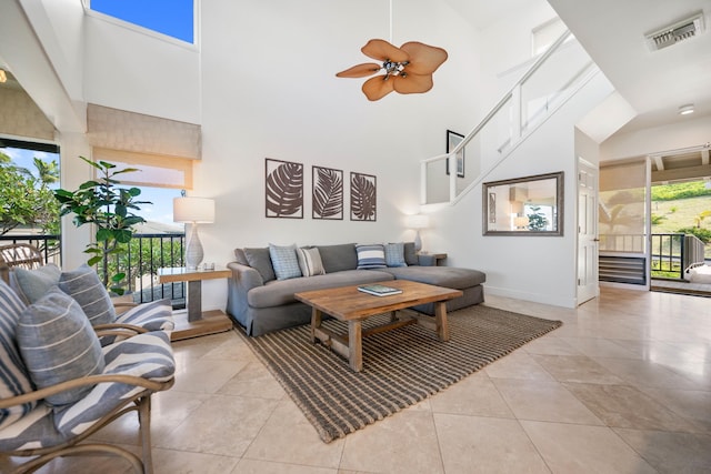 tiled living room with high vaulted ceiling, a wealth of natural light, and ceiling fan