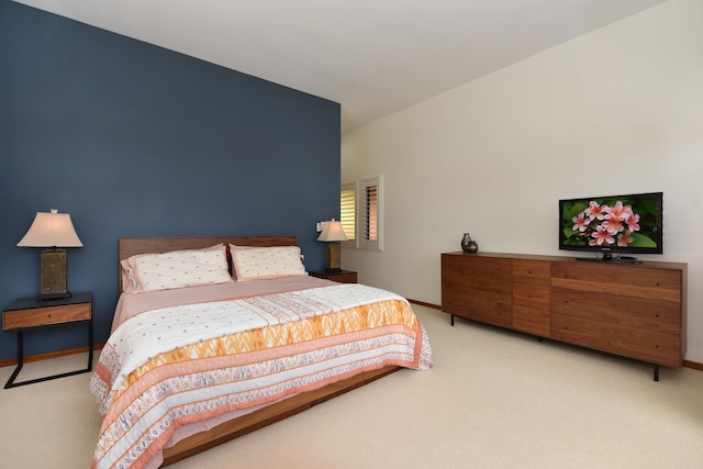 bedroom featuring light carpet