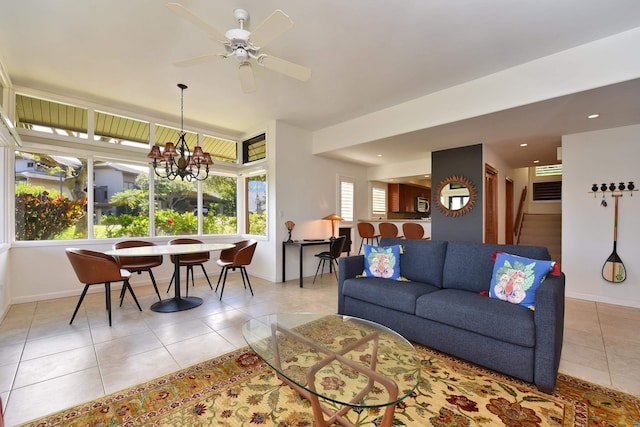 living room featuring light tile flooring and ceiling fan with notable chandelier