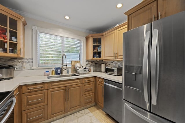 kitchen with stainless steel appliances, tasteful backsplash, sink, ornamental molding, and light tile patterned floors