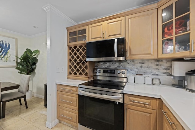 kitchen featuring crown molding, light tile patterned floors, stainless steel appliances, and tasteful backsplash