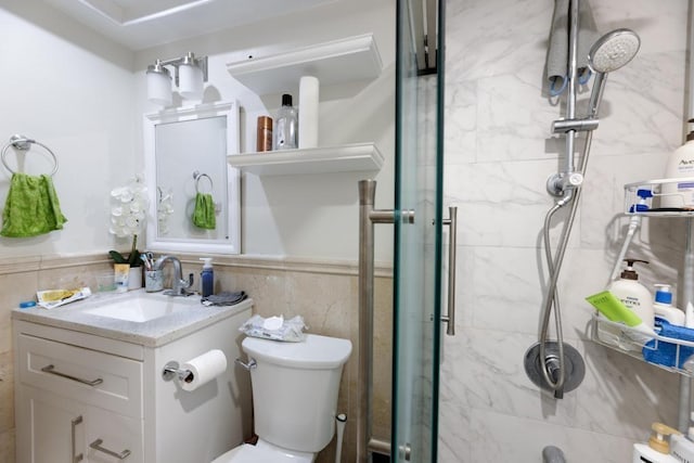 bathroom featuring vanity, toilet, tile walls, and an enclosed shower