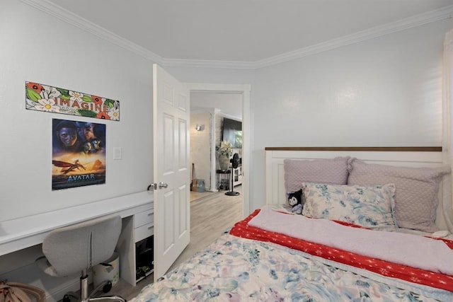 bedroom with crown molding and light hardwood / wood-style floors