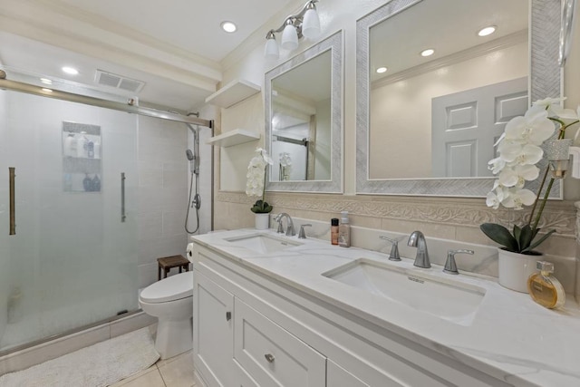 bathroom featuring tile patterned flooring, toilet, a shower with door, and vanity