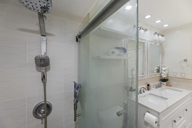 bathroom featuring sink, an enclosed shower, and crown molding