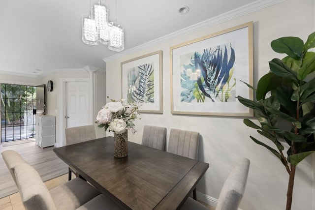 dining space featuring crown molding and an inviting chandelier