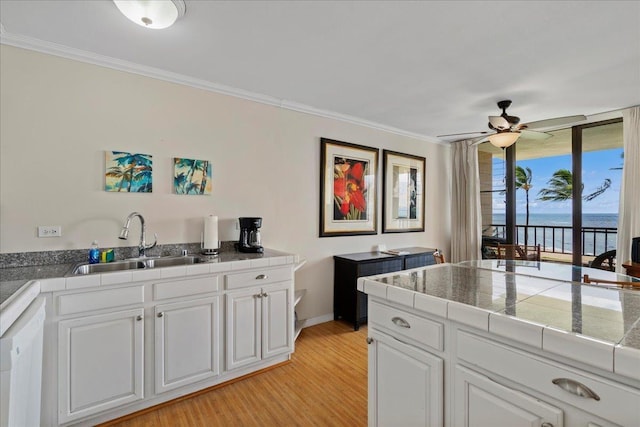 800 S Kihei Rd Unit 504, Kihei, HI 96753 - kitchen with a sink, a water view, ceiling fan, ornamental molding, and light wood-style floors
