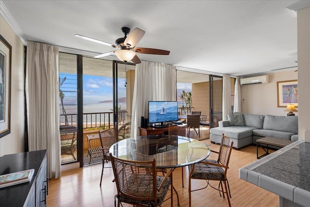 800 S Kihei Rd Unit 504, Kihei, HI 96753 - living room with an AC wall unit, expansive windows, light wood-style floors, ceiling fan, and ornamental molding