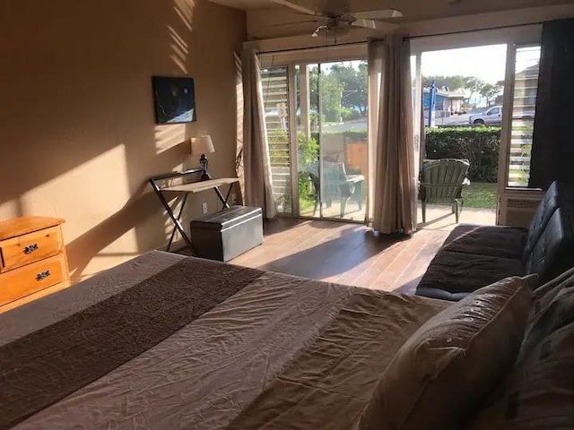 bedroom featuring ceiling fan, hardwood / wood-style flooring, and access to exterior