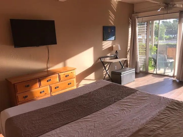 bedroom featuring light hardwood / wood-style floors, ceiling fan, and access to outside