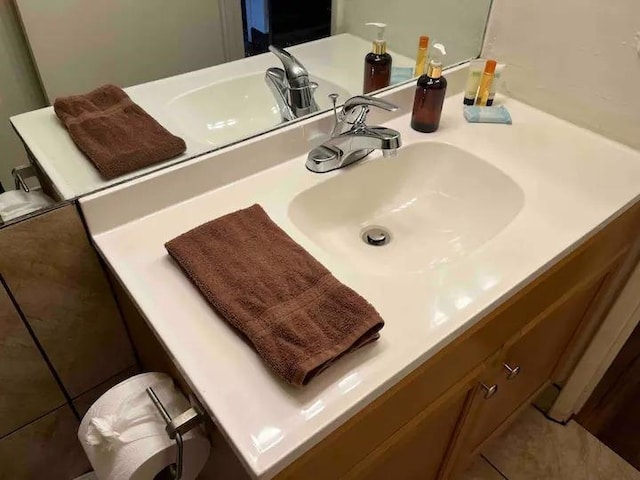 bathroom featuring oversized vanity and tile flooring