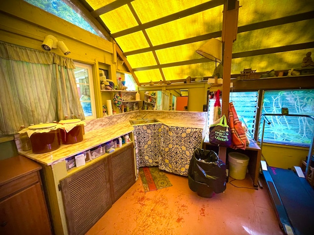 kitchen with a healthy amount of sunlight and vaulted ceiling