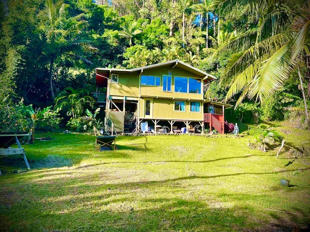 back of house featuring a yard and a deck