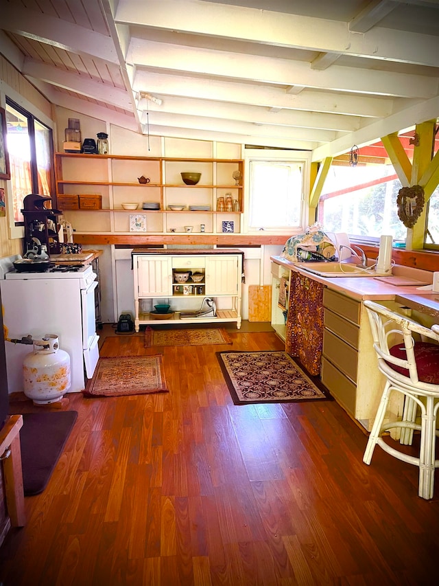 kitchen featuring wooden ceiling, vaulted ceiling with beams, dark hardwood / wood-style flooring, and white gas range oven