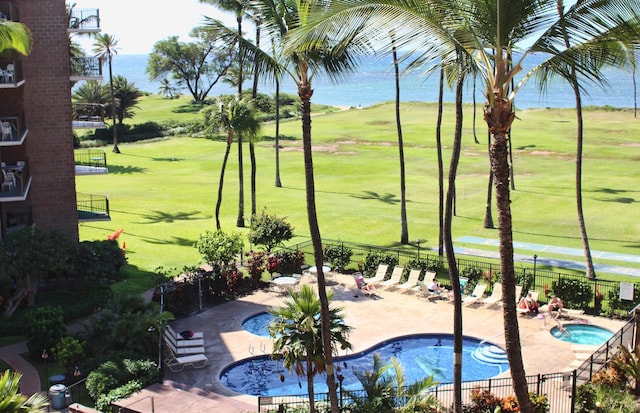 view of swimming pool with a yard and a patio