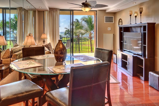 dining room with ceiling fan, expansive windows, and a healthy amount of sunlight