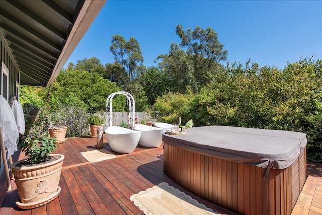 wooden deck with a hot tub