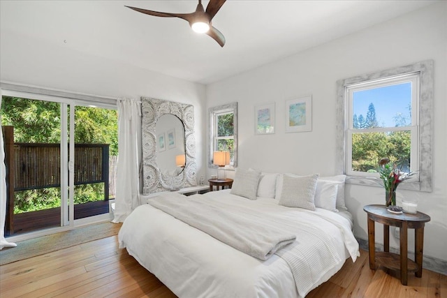 bedroom with ceiling fan, hardwood / wood-style floors, and access to exterior