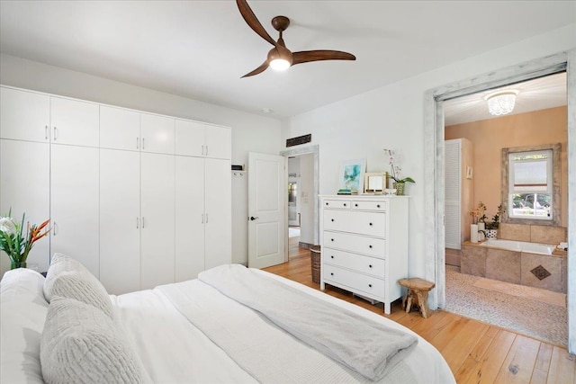 bedroom featuring a closet, light wood-style flooring, and a ceiling fan