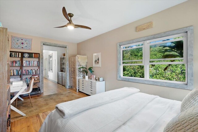 bedroom featuring light wood-type flooring and a ceiling fan