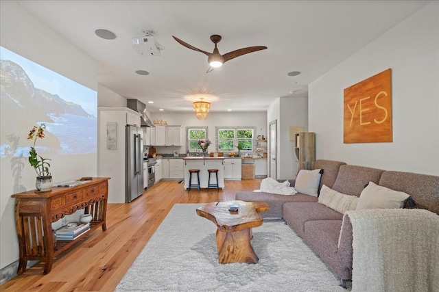 living area featuring ceiling fan and light wood-style floors