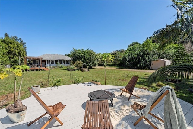 deck featuring a shed, an outdoor structure, and a yard