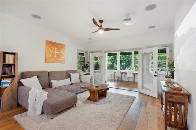 living area featuring light wood-style floors and ceiling fan