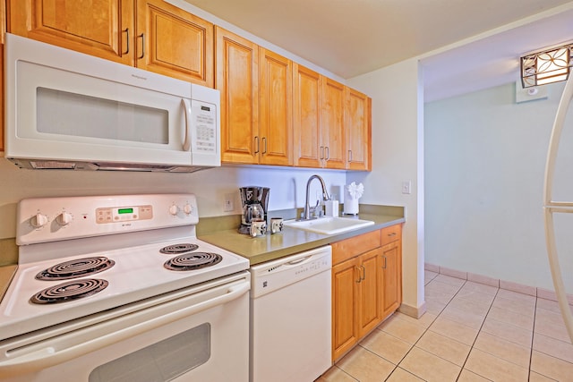 kitchen featuring light tile patterned flooring, white appliances, and sink