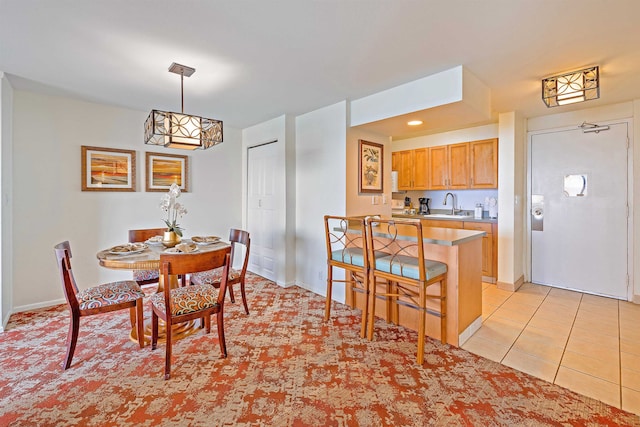 dining area featuring light tile patterned floors and sink