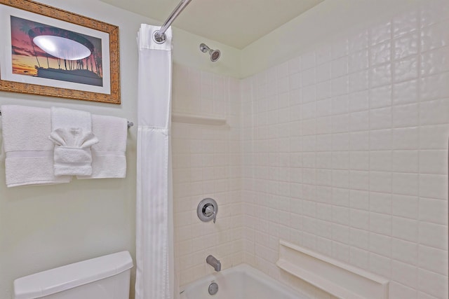 bathroom featuring shower / tub combo and toilet