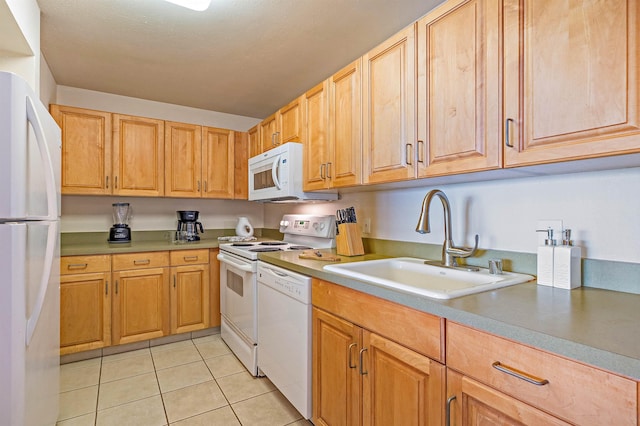 kitchen featuring light tile patterned flooring, white appliances, and sink