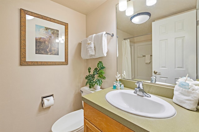 bathroom with vanity, a shower with shower curtain, and toilet