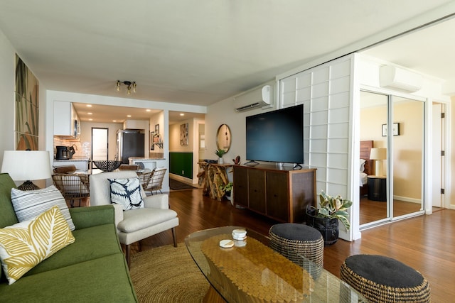 100 Hauoli St Unit 106, Wailuku, HI 96793 - living room with wood finished floors and a wall mounted air conditioner