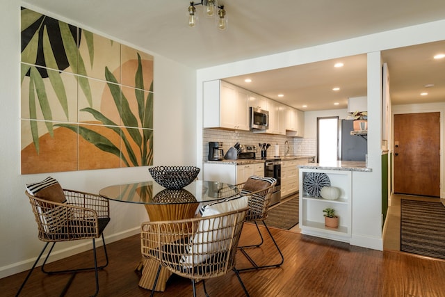 100 Hauoli St Unit 106, Wailuku, HI 96793 - dining space with dark wood-style floors and recessed lighting