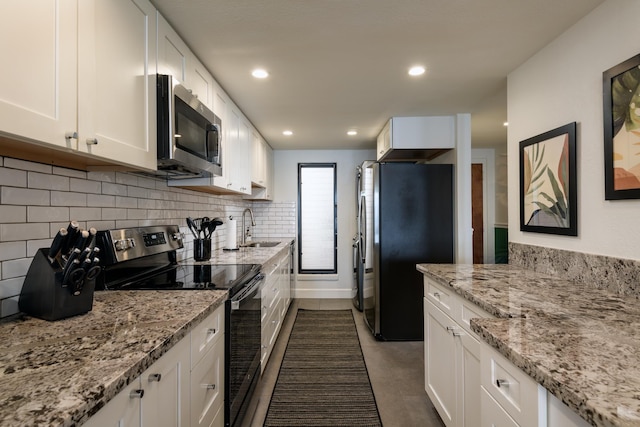 100 Hauoli St Unit 106, Wailuku, HI 96793 - kitchen featuring stainless steel appliances, white cabinets, decorative backsplash, light stone countertops, and dark tile patterned floors