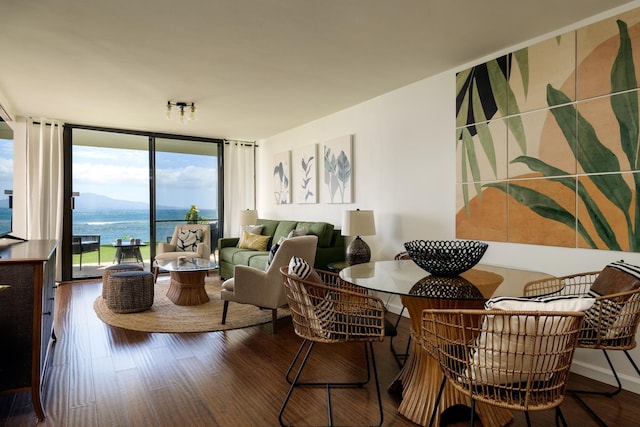 100 Hauoli St Unit 106, Wailuku, HI 96793 - dining area featuring a wall of windows, wood finished floors, and a water view