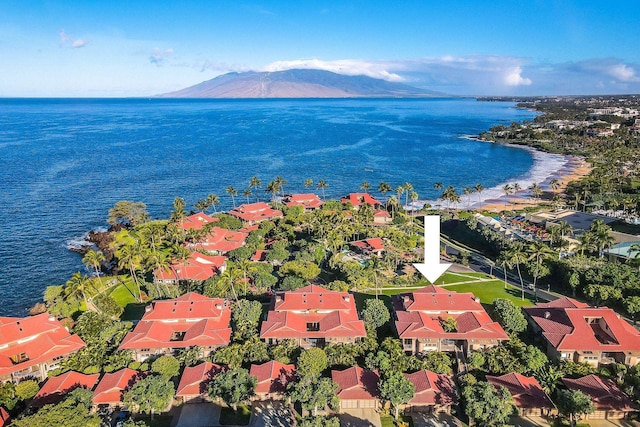 drone / aerial view featuring a water and mountain view