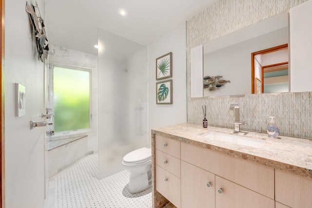 bathroom featuring tile patterned flooring, backsplash, walk in shower, toilet, and vanity