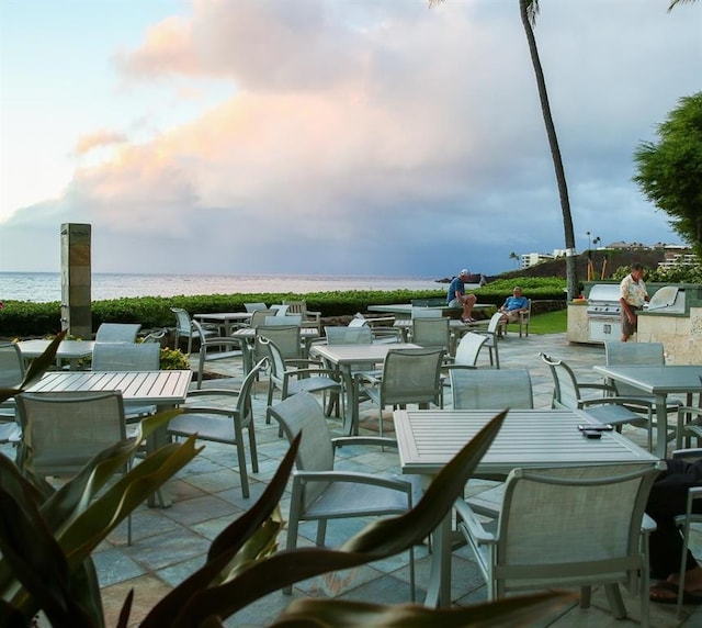 view of patio featuring area for grilling and a water view