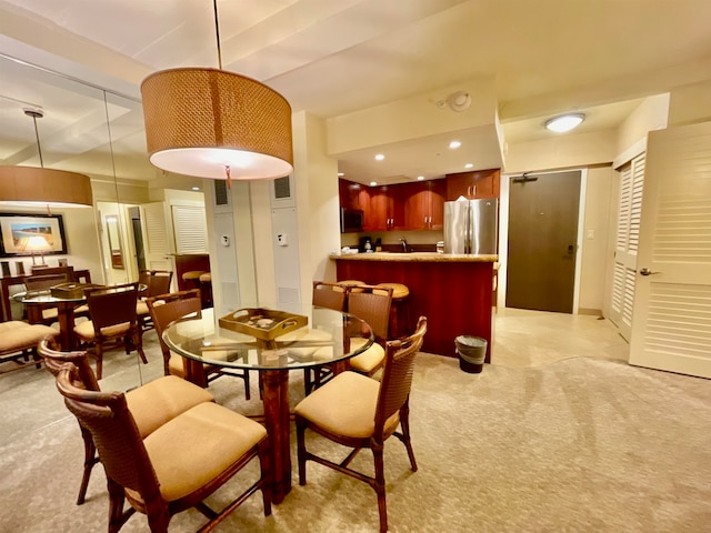 dining space featuring light colored carpet