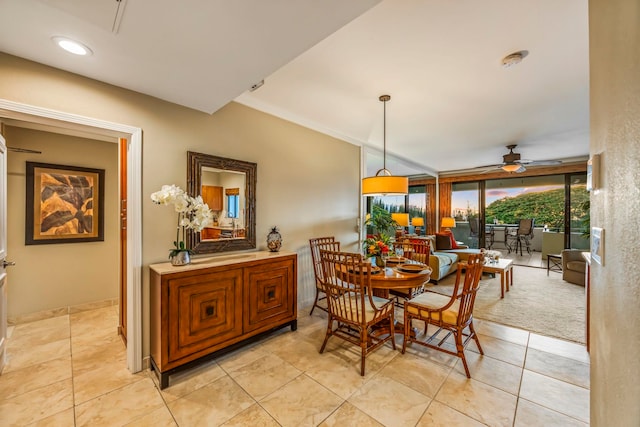 dining area with ceiling fan and expansive windows