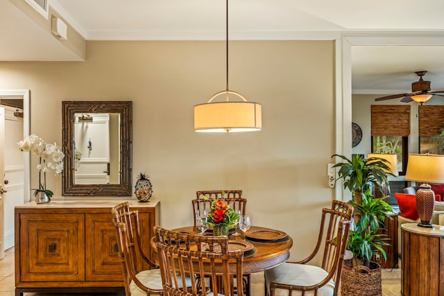 dining room with ornamental molding, ceiling fan, and light tile patterned floors