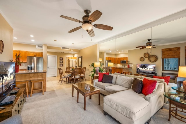 tiled living room featuring ceiling fan and crown molding