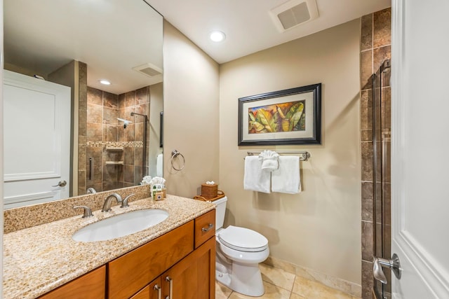 bathroom featuring vanity, a shower with shower door, toilet, and tile patterned floors